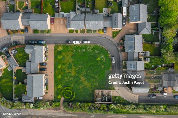 drone view of modern housing development in the uk - garden center parking lot stock pictures, royalty-free photos & images