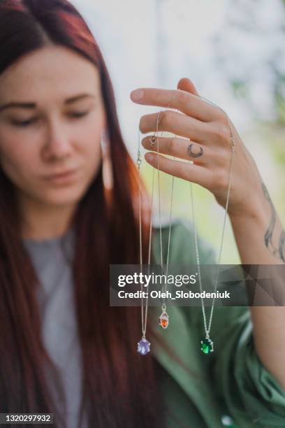 woman holding three pendants - pendant stock pictures, royalty-free photos & images