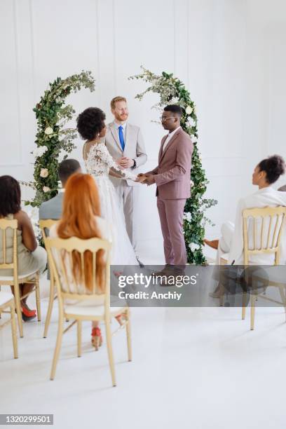 bride and groom exchanging wedding vows - covid wedding stock pictures, royalty-free photos & images