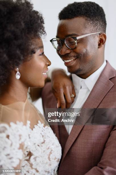 portrait of newlyweds,  groom and bride embracing near altar - covid wedding stock pictures, royalty-free photos & images