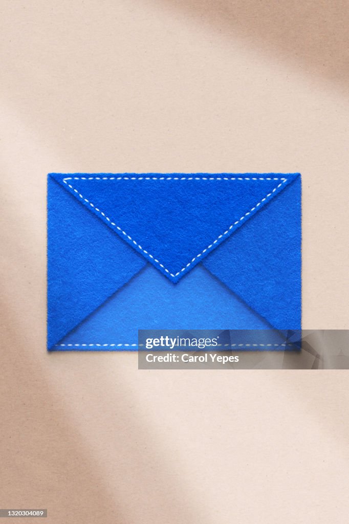 Blue envelope made of felt with long shadows