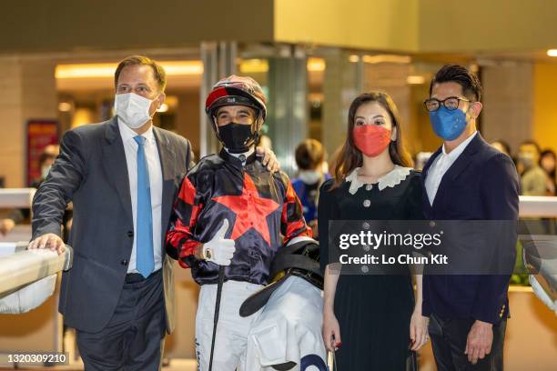 Jockey Joao Moreira, trainer Caspar Fownes, owner Aaron Kwok Fu-shing and his wife Moka Fang Yuan celebrate after Dancing Fighter winning the Race 7...