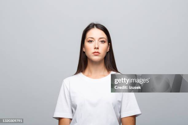 headshot of confident young woman - woman white t shirt stock pictures, royalty-free photos & images