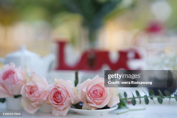 romantic dining table decoration with pink rose - wedding gift table stock pictures, royalty-free photos & images