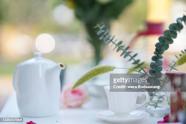 tea table decorated in the garden - afternoon tea party stock pictures, royalty-free photos & images