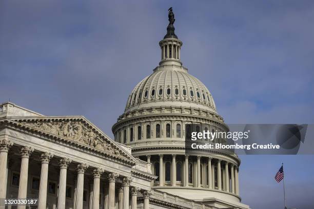 the u.s. capitol building and american flag - senaat stockfoto's en -beelden