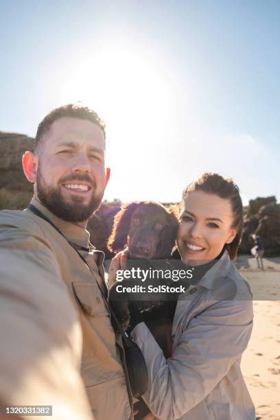beach selfie with our puppy - self portrait photography stock pictures, royalty-free photos & images