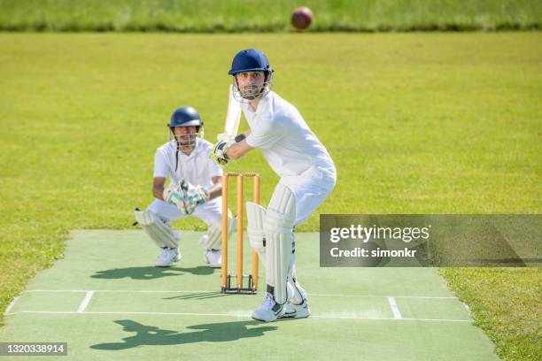 batsman in stance ready to hit the ball - indian cricket player stock pictures, royalty-free photos & images