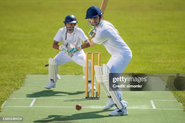 batsman in stance ready to hit the ball - batsman stock pictures, royalty-free photos & images