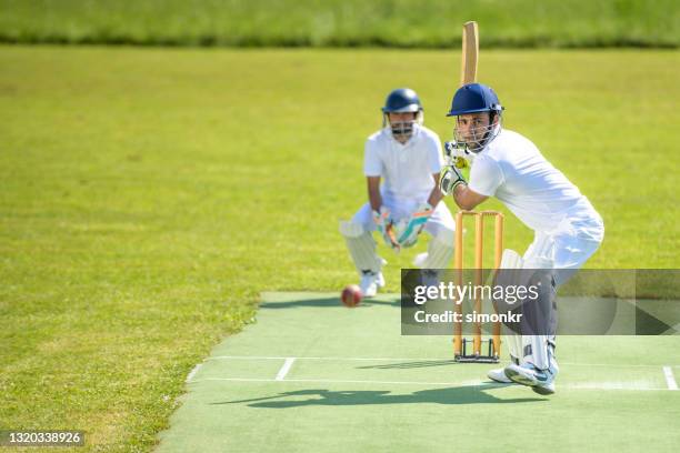 batsman in stance ready to hit the ball - cricket bat stock pictures, royalty-free photos & images
