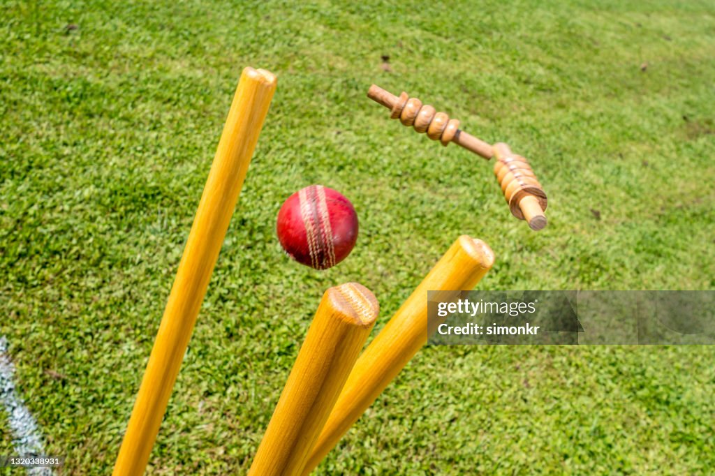 Cricket ball hitting the stumps