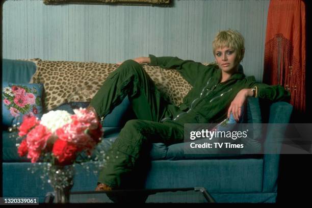 Actress Britt Ekland posing in a green jumpsuit and pixie cut hairstyle, circa 1979.