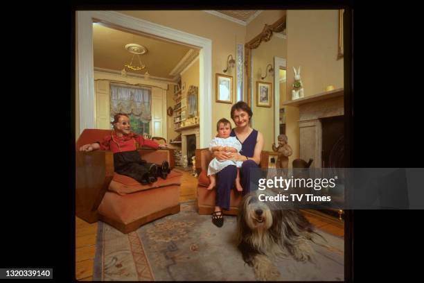 Actress Janine Duvitski photographed at home with her young daughter and Old English sheepdog, circa 1994.