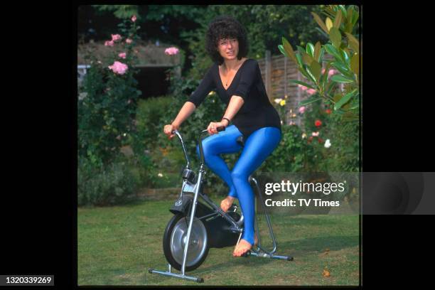 Actress Jill Gascoine using an exercise bike at home, circa 1984.