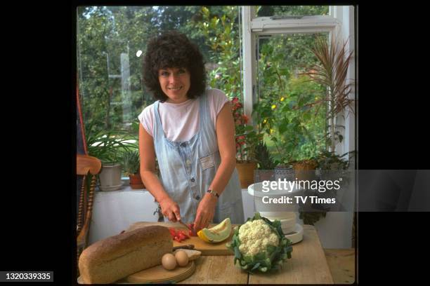 Actress Jill Gascoine photographed preparing food at home, circa 1984.