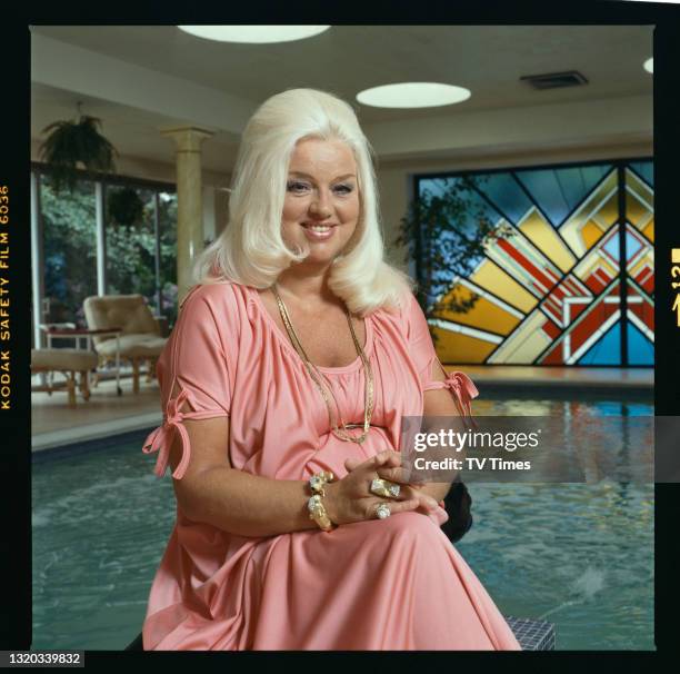 Actress Diana Dors photographed at home by a swimming pool, circa 1983.