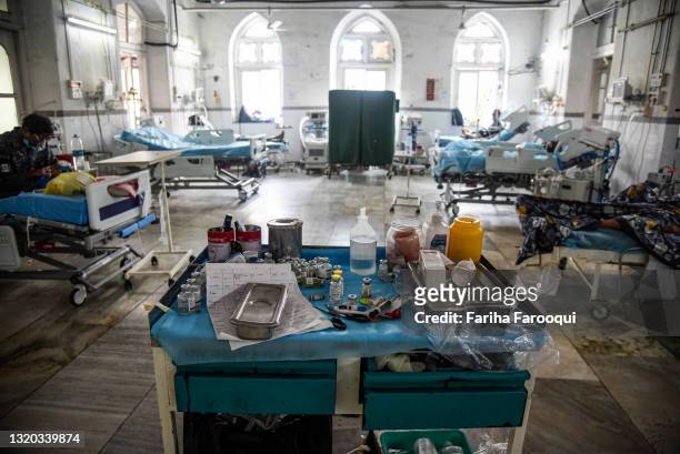 Medications and the medical notes of patients who have Covid-19 sit on a trolley in an ICU ward at the government-run St. George hospital on May 27,...