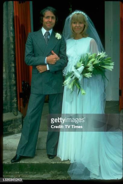 Actors Richard O'Sullivan and Tessa Wyatt in character as Robin and Victoria Tripp while filming a wedding scene in the sitcom Robin's Nest, circa...