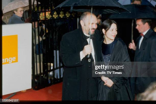 Director Anthony Minghella and his wife Carolyn Choa photographed at the BAFTA Film Awards, circa 1998.