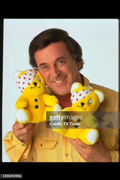 Children In Need presenter Terry Wogan with two Pudsey Bear toys, circa 1991.