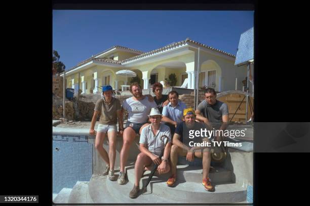 The cast of comedy drama series Auf Wiedersehen, Pet photographed on location in Spain, including Kevin Whately, Pat Roach, Gary Holton, Tim Healy,...