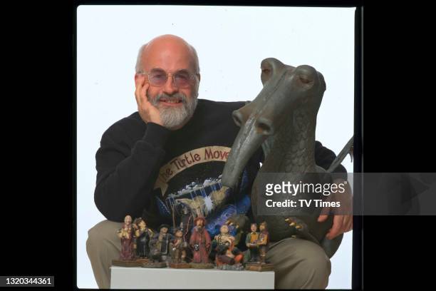 English fantasy author Terry Pratchett photographed with several models of his characters, circa April 1997.