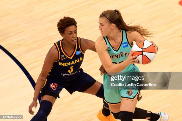Sabrina Ionescu of the New York Liberty looks to make a move on Danielle Robinson of the Indiana Fever at Bankers Life Fieldhouse on May 16, 2021 in...