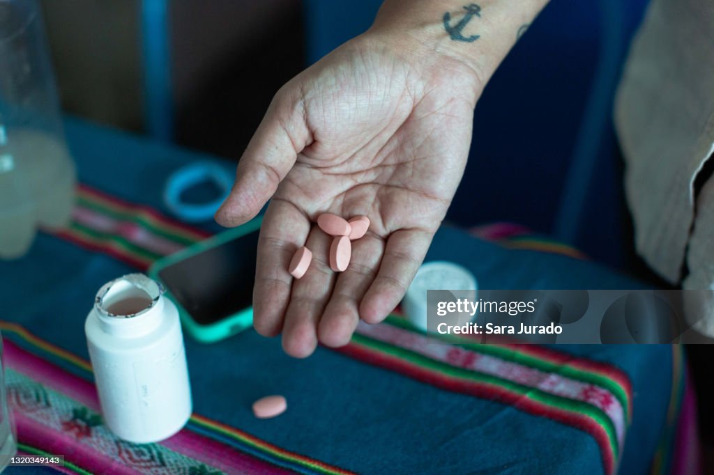 Young latina woman taking medicine