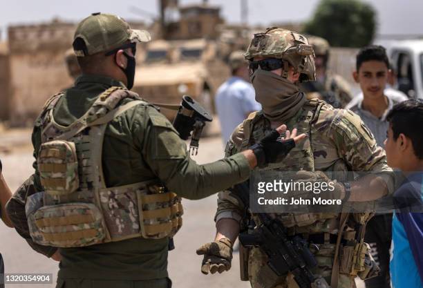 Army soldiers speaks with an Kurdish soldier while on joint patrol with local allied forces on May 25, 2021 near the Turkish border in northeastern...
