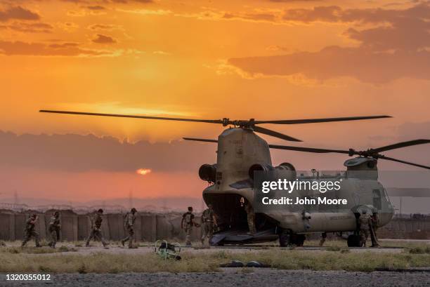 Army soldiers board a CH-47 Chinook helicopter while departing a remote combat outpost known as RLZ on May 25, 2021 near the Turkish border in...