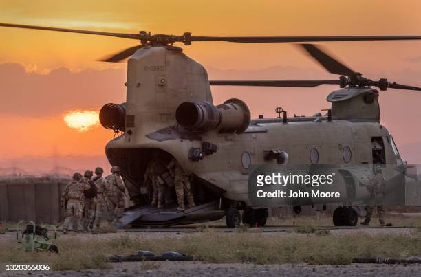 Army soldiers board a CH-47 Chinook helicopter while departing a remote combat outpost known as RLZ on May 25, 2021 near the Turkish border in...