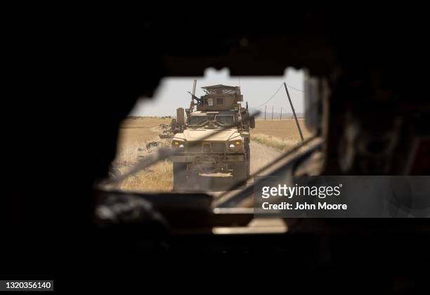 Army MRAP patrol vehicle passes by, seen through a bulletproof windshield of another armored vehicle on May 26, 2021 near the Turkish border in...