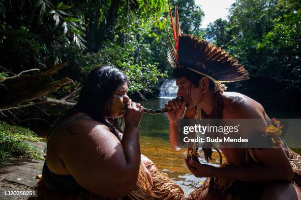 Indigenous leader Apohinã Pataxó blows a dust made with a mixture of smashed herbs through the nose of cacique Nawã Pataxó using a tube called rapé...