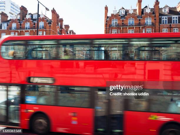 abstract of red bus on front of residential buildings - marylebone photos et images de collection