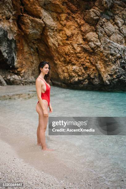 young woman walks into mediterranean sea - personal appearance stock pictures, royalty-free photos & images