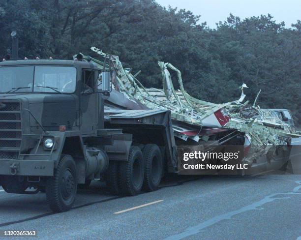 Flatbed truck drives north on Long Island's Route 24 towards Calverton, New York on August 3, 1996 containing wreckage from the TWA Flight 800 plane...