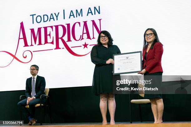 Sandy Hoa Dang receives an Outstanding Americans by Choice Recognition from Amanda Baran, Chief of Officer of Policy and Strategy for United States...