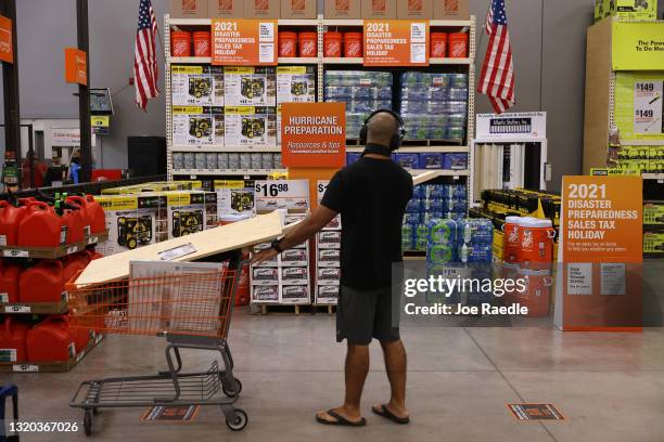 Home Depot customer looks at hurricane preparation supplies for sale on May 27, 2021 in Doral, Florida. Beginning on May 28th, shoppers in Florida...