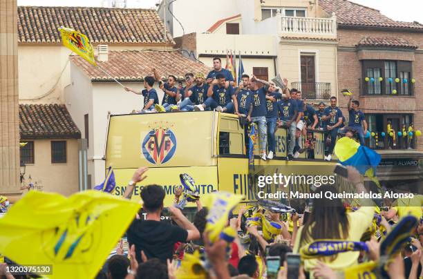 Fans celebrate with the Villarreal CF team during the UEFA Europa League trophy bus parade after winning the UEFA Europa League final against...