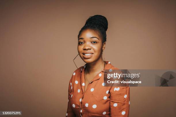 confident woman in studio - brown background stock pictures, royalty-free photos & images