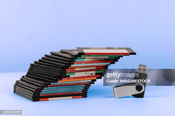 old floppy disk mountain compared to usb memory. - byte foto e immagini stock