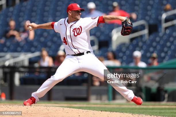 Daniel Hudson of the Washington Nationals pitches to a Cincinnati Reds batter during the eighth inning after the game was suspended because of rain...