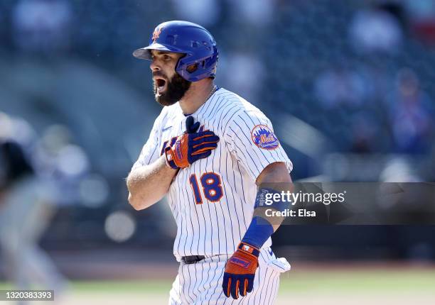 Jose Peraza of the New York Mets celebrates after hitting an RBI single in the fourth inning against the Colorado Rockies during game two of a double...