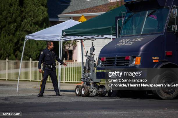 San Jose police next to a robot outside the home of Samuel James Cassidy, Thursday, May 27 in San Jose, Calif. A shooting on Wednesday at the Valley...
