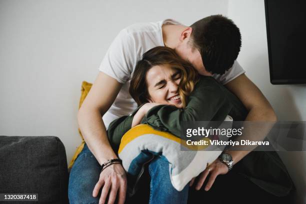beautiful young couple relaxing at home. charming couple having fun together - girlfriend stock pictures, royalty-free photos & images