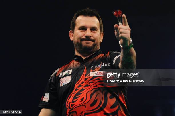 Jonny Clayton of Wales celebrates in his match against Dimitri Van den Bergh of Belgium during Night 16 of the Unibet Premier League Darts at...