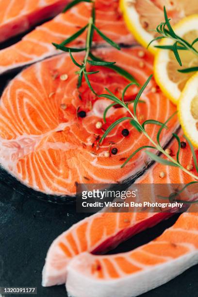 salmon. raw trout red fish steak with ingredients for cooking. cooking salmon, sea food. healthy eating concept - trout stock photos et images de collection