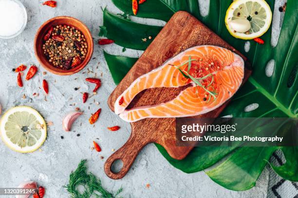 salmon. raw trout red fish steak with ingredients for cooking. cooking salmon, sea food. healthy eating concept - salmon foto e immagini stock