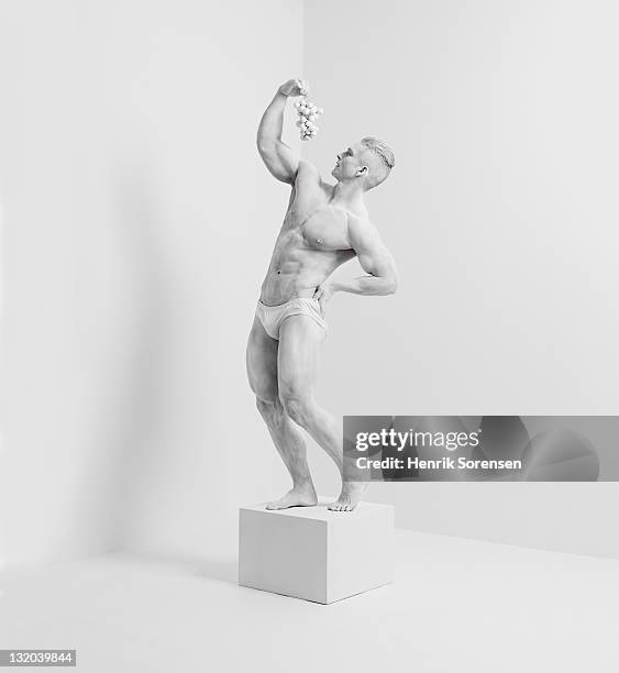 white statue in white room with grapes - food sculpture stock pictures, royalty-free photos & images
