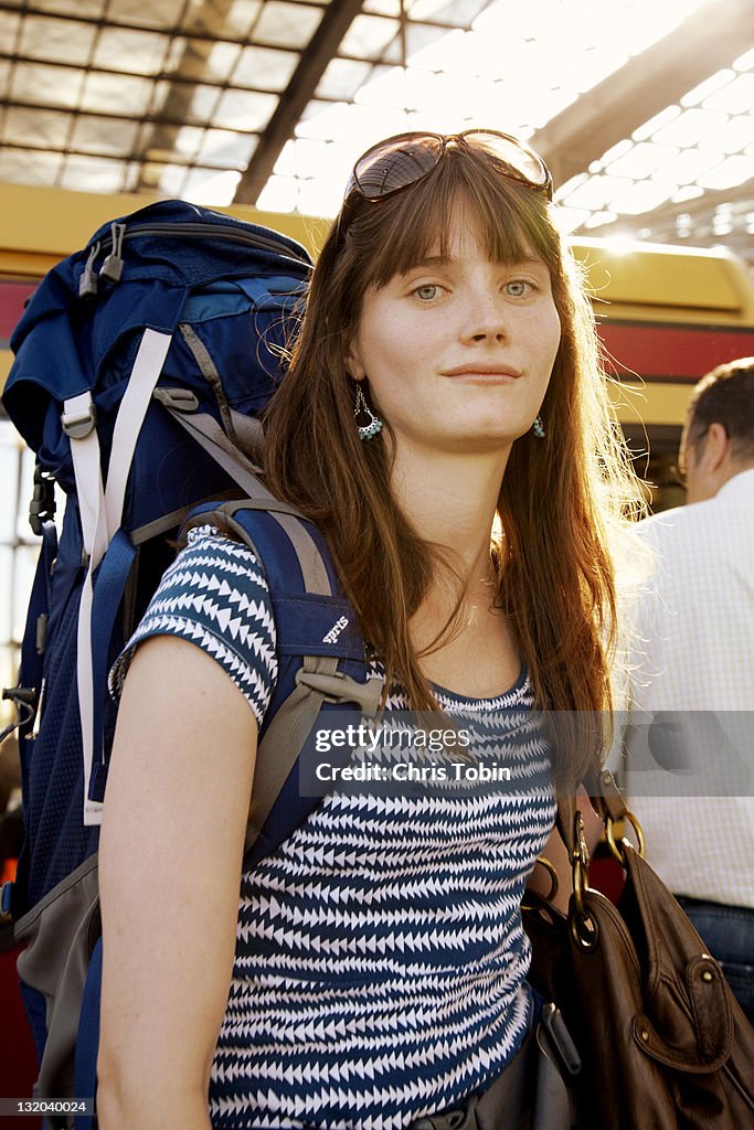 Girl with backpack in train station